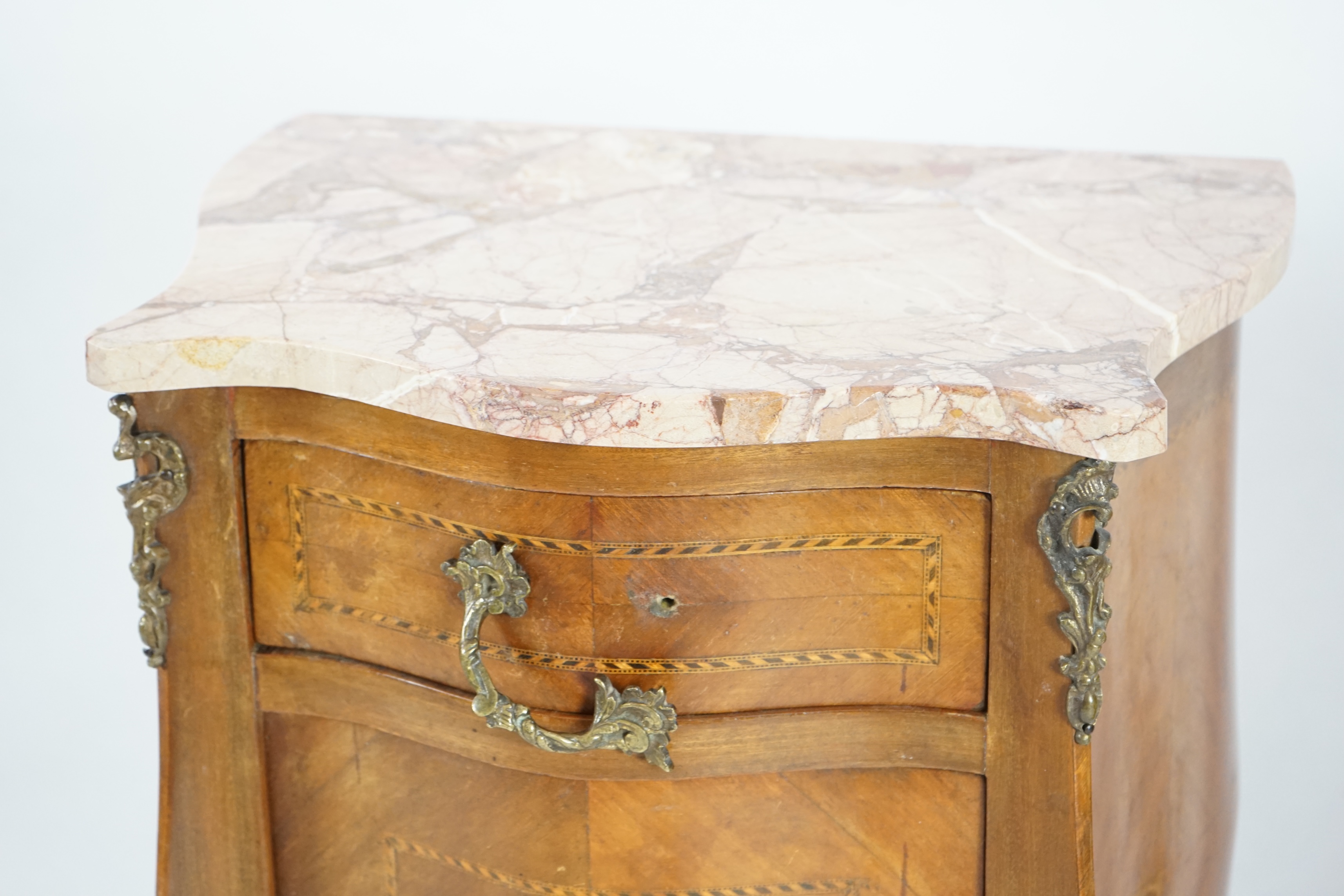 A pair of French marbled top inlaid mahogany bedside chests